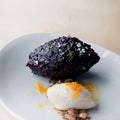 Baked chocolate ganache with spicy hazelnuts and orange oil
