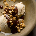 Halva ice cream with chocolate sauce and peanuts