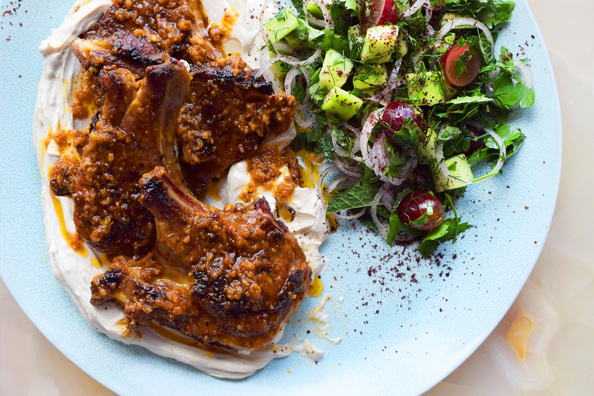 Lamb chops with pilpelchuma oil, tahini yoghurt and herb salad