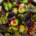 Pan fried brussels sprouts and shallots with pomegranate and purple basil