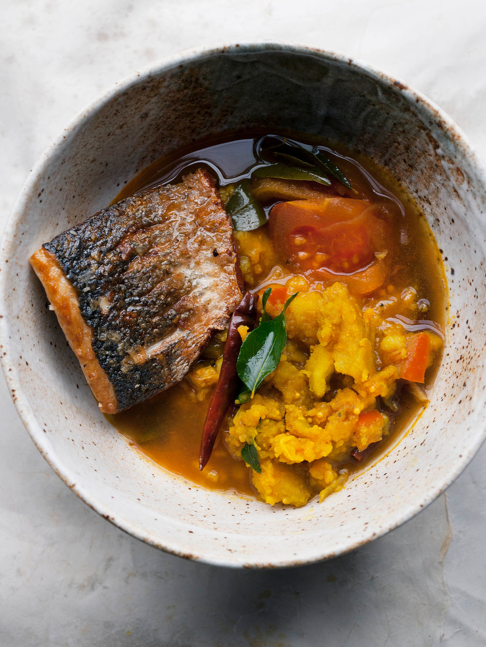 Sea bass and turmeric potatoes in rasam broth
