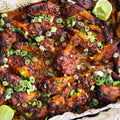 Sweet and smokey chicken wings with spring onions and lime