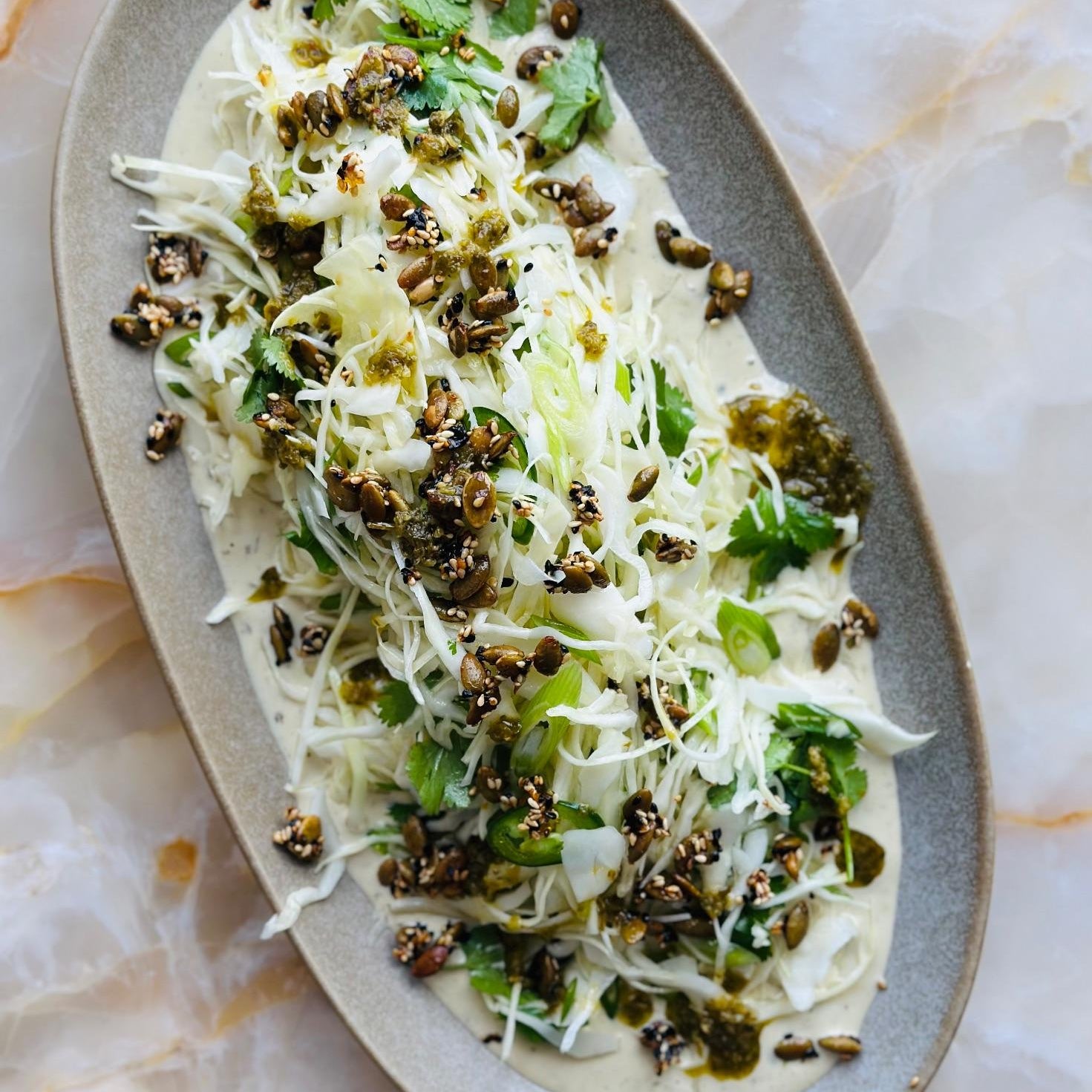 Green harissa and tahini slaw with pumpkin seed brittle